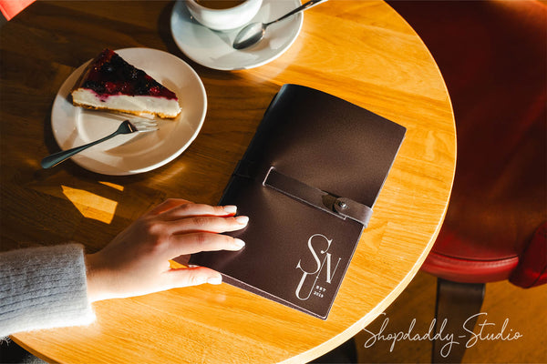 Dark brown menu cover made from thick leather, radiating a rustic yet refined aesthetic.