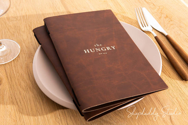 Recycled antique brown leather menu cover with elastic band, perfect for restaurants.