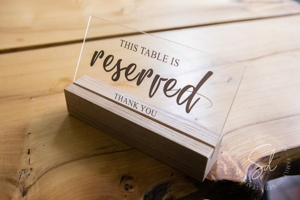 wooden reserved table seating sign