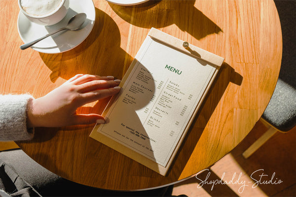 A stylish plywood menu board featuring a simple brass screw to securely hold papers in place