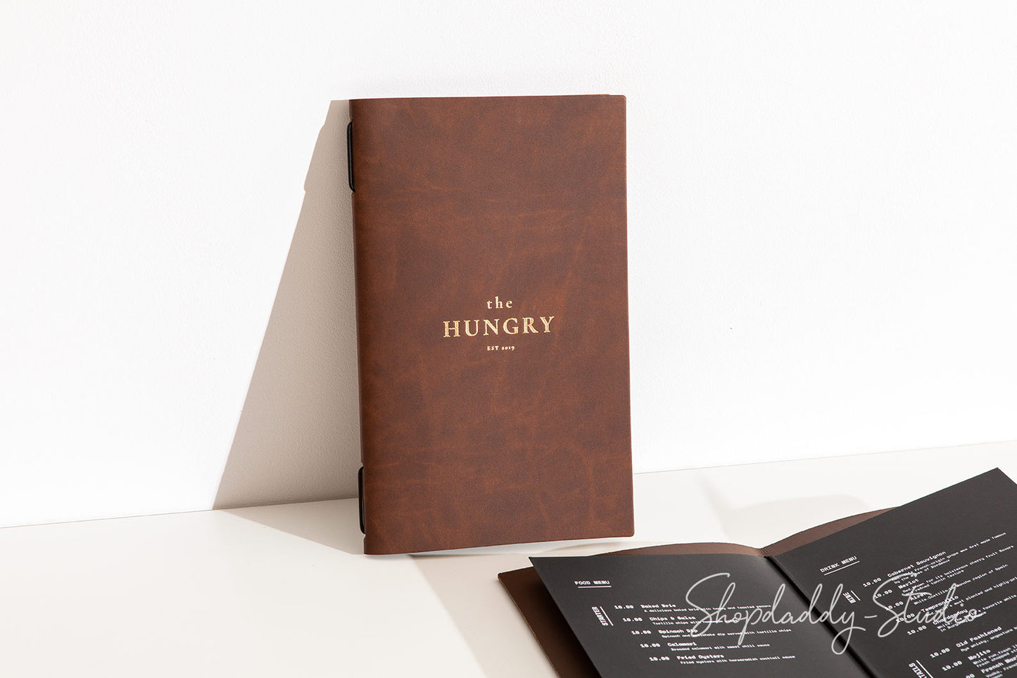 Antique brown leather menu cover crafted from sustainable recycled materials.