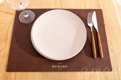 Close-up of recycled antique brown leather placemat showcasing its refined design.
