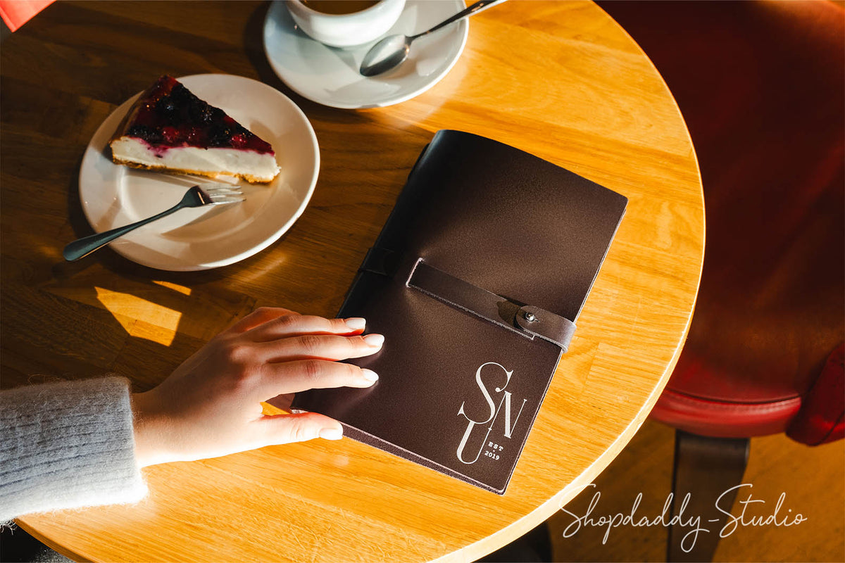 Dark brown menu cover made from thick leather, radiating a rustic yet refined aesthetic.