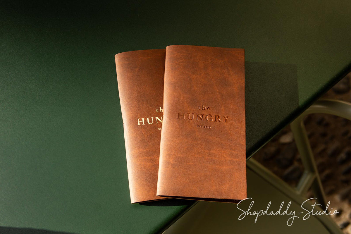 Eco-friendly check presenter in antique brown recycled leather, featuring a pen holder.