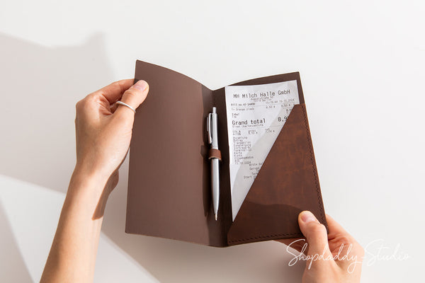 Elegant check holder in antique brown recycled leather, designed with a pen loop.