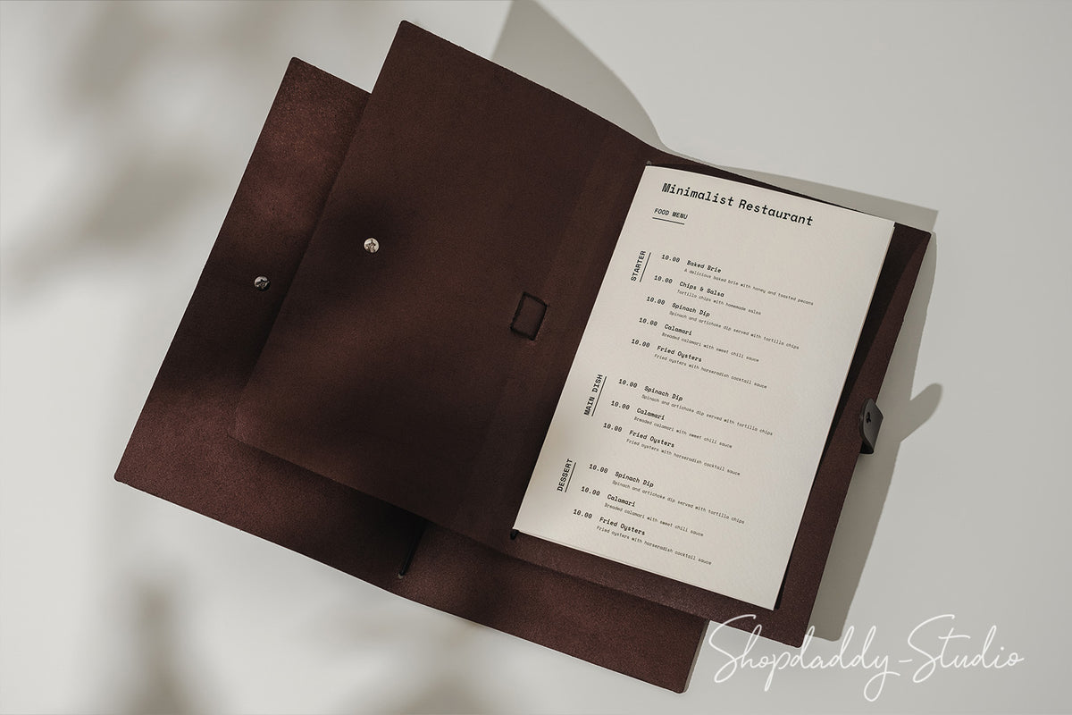 Handcrafted dark brown leather menu cover with a belt closure, blending durability and elegance.