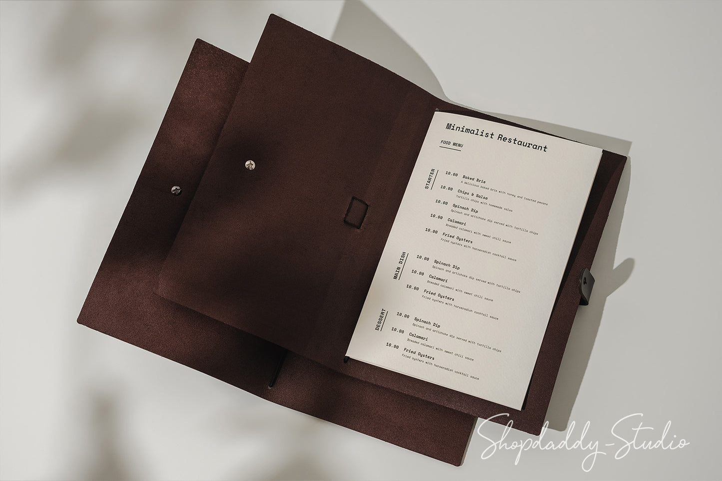 Handcrafted dark brown leather menu cover with a belt closure, blending durability and elegance.