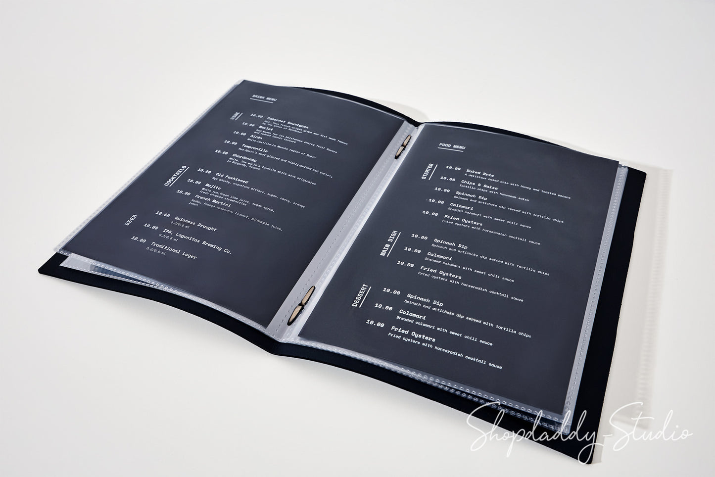 An open black binder or menu folder with two dark gray pages printed with white text, photographed on a clean white background. A faint 'Shopaddy Studio' watermark appears in the lower right corner.