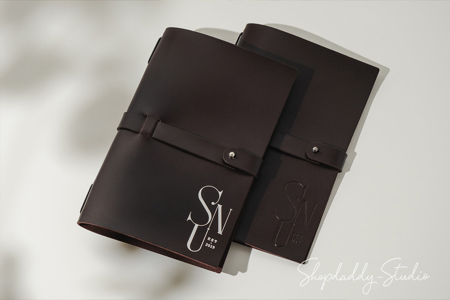 Premium dark brown leather menu cover featuring high-quality craftsmanship and a belt clasp
