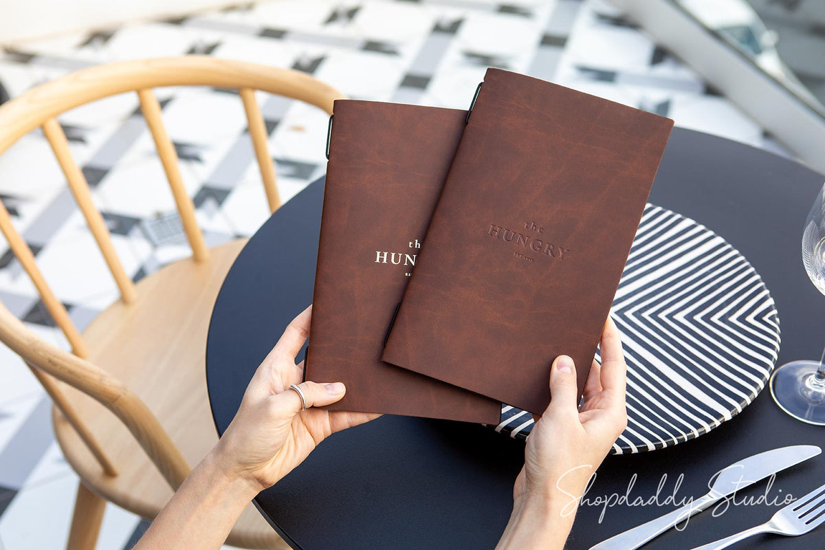 Rustic recycled bonded leather menu holder with elastic band for professional use.