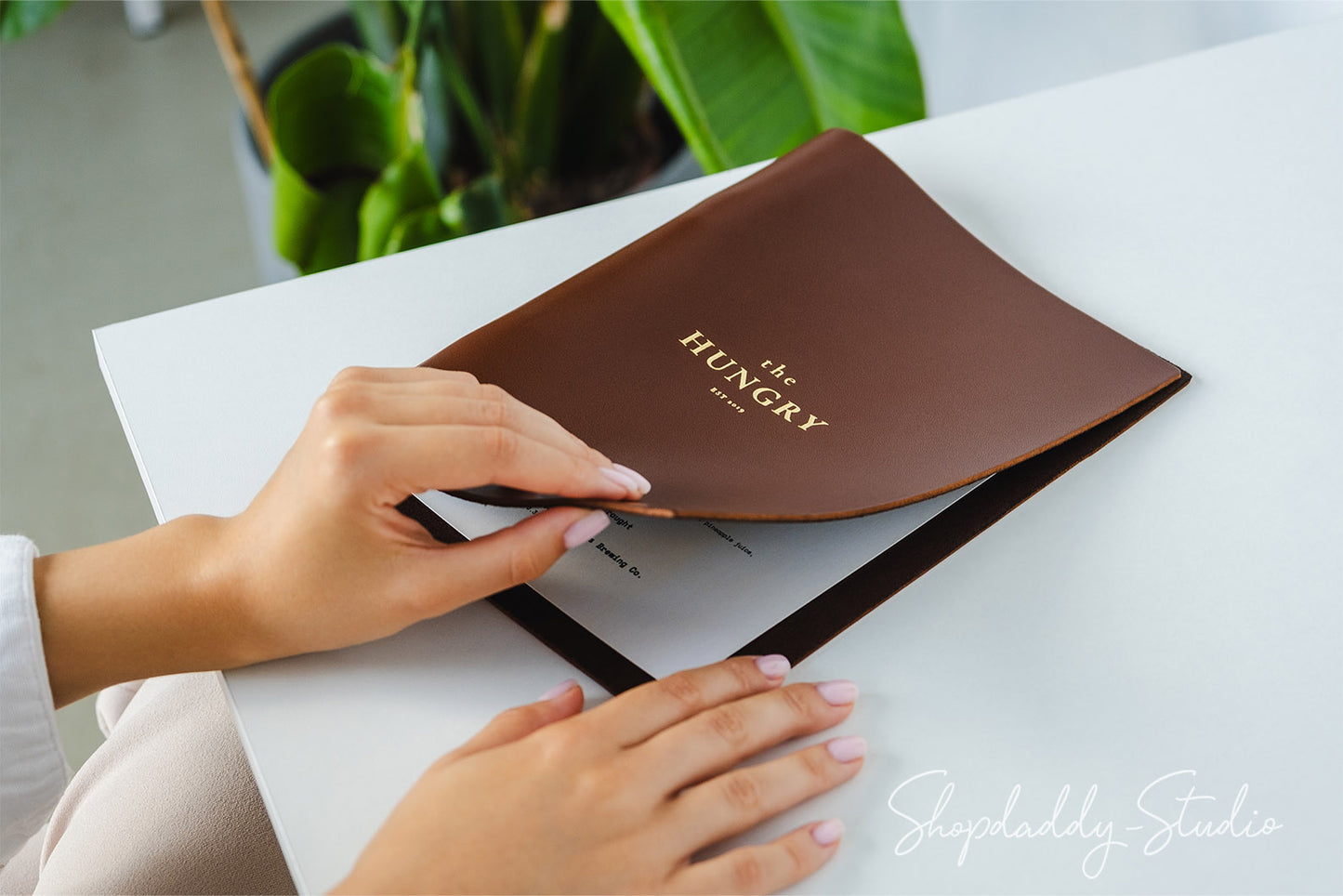 brown leather menu holder with ring mechanism for cocktail menu