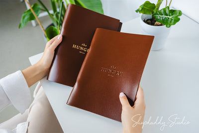 brown leather menu holder with ring mechanism for drink menu