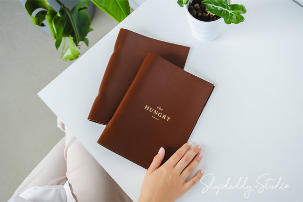 brown leather menu holder with ring mechanism for restaurant