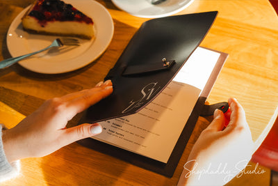 custom dark brown leather menu cover, showcasing its rich texture and durable stitching