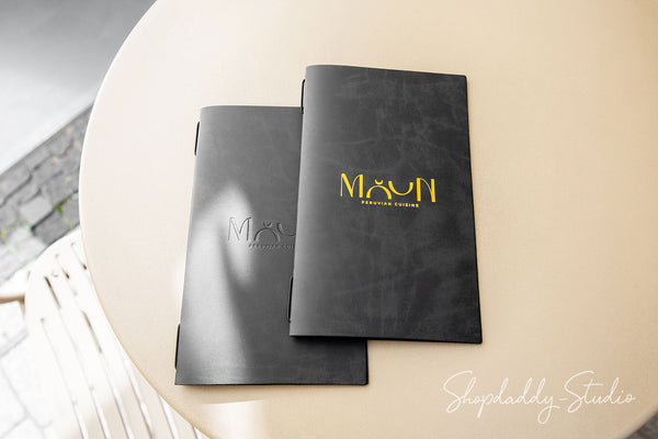 Minimalist leather menu cover on wooden restaurant table