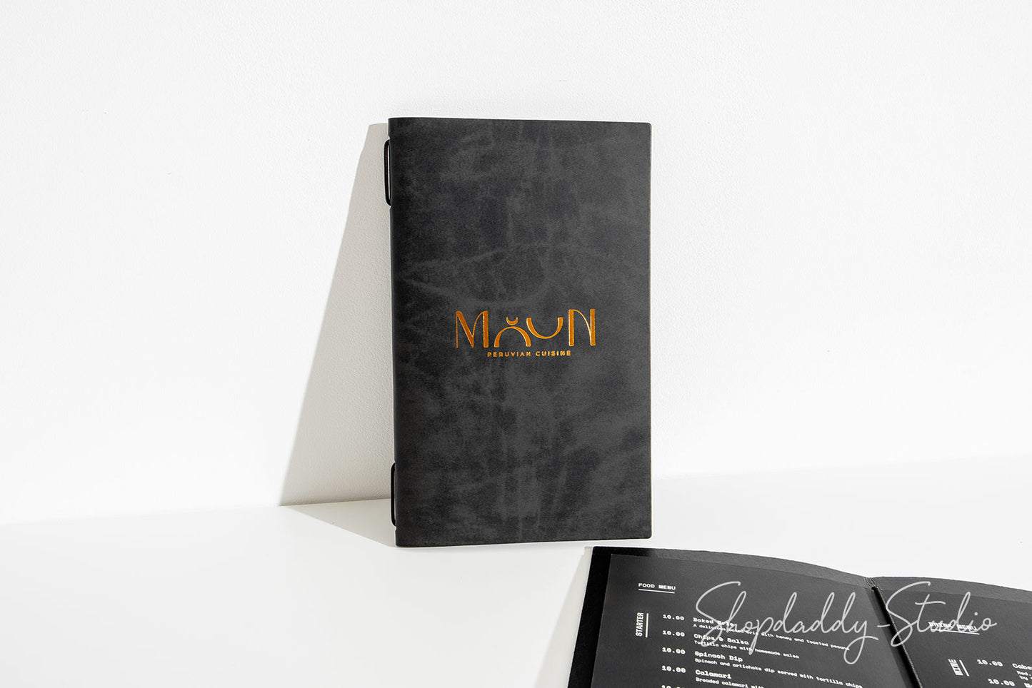 Close-up of leather texture and stitching on menu cover