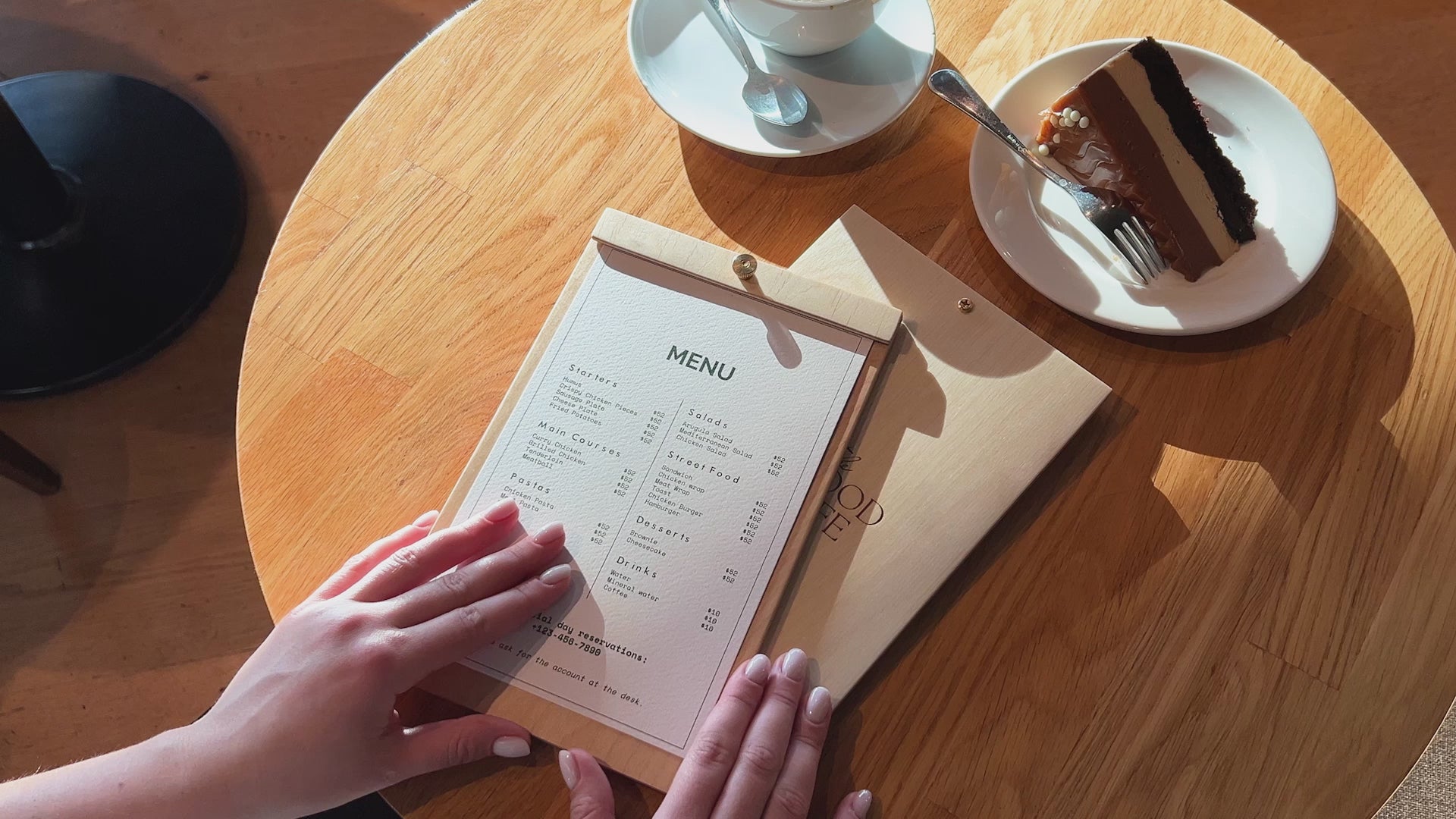 Close-up of a wooden menu board, highlighting the smooth plywood surface and central brass screw detail