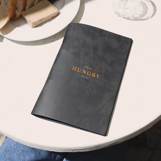 Recycled leather menu holders arranged for bulk order display