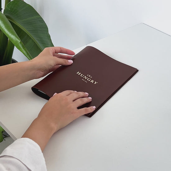 brown leather menu holder with ring mechanism