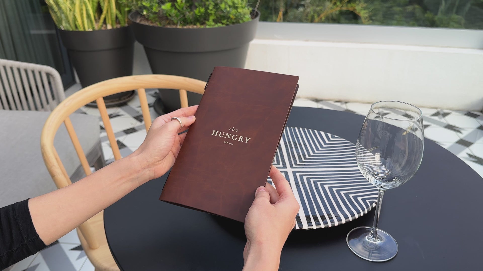 Recycled antique brown leather menu cover with elastic band, perfect for restaurants.