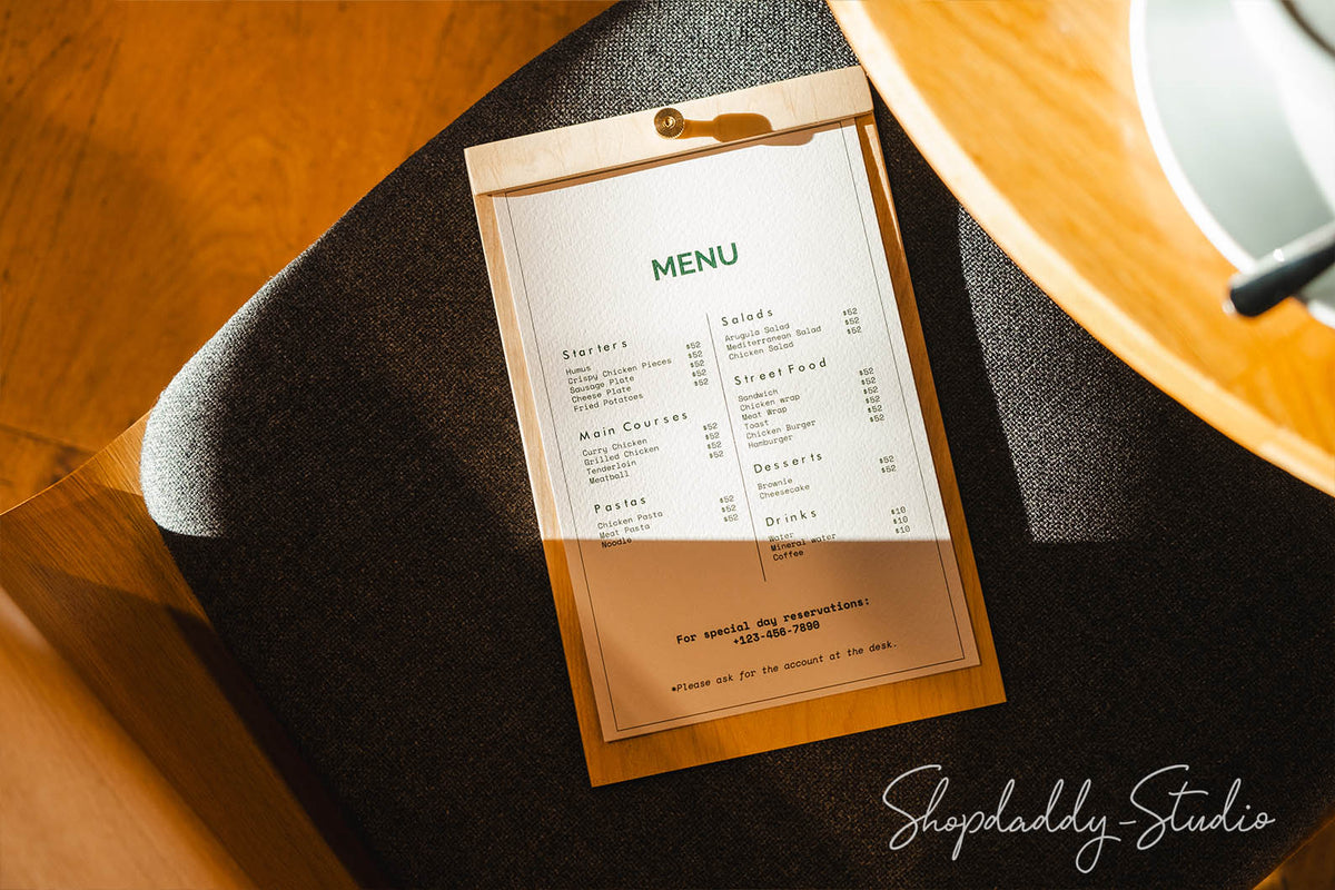 wooden menu board, highlighting the smooth plywood surface and central brass screw detail